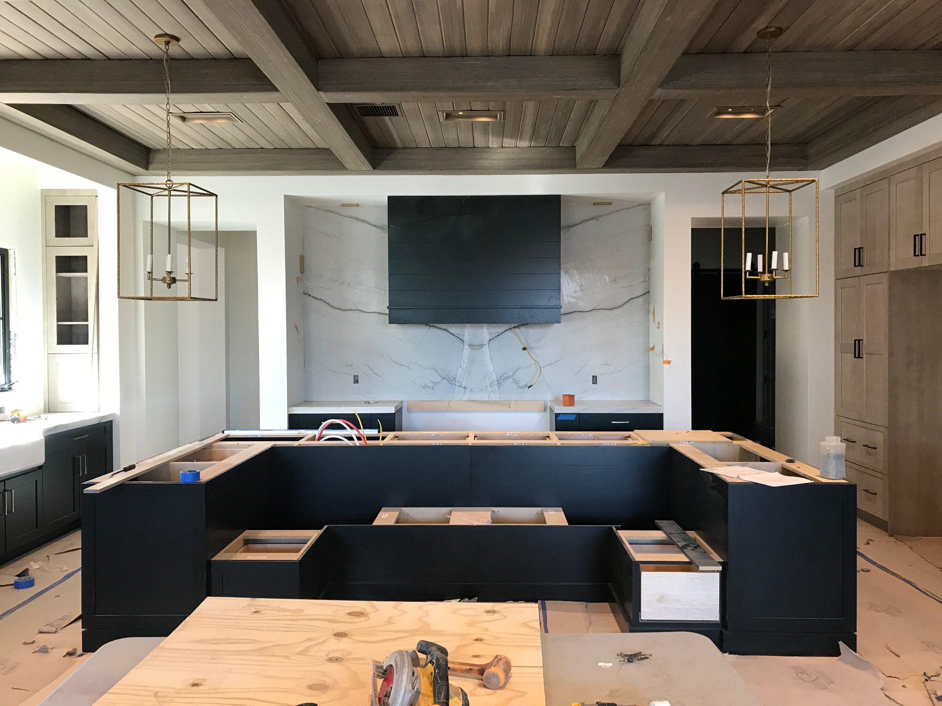 Custom island and millwork being fitted to field conditions on site