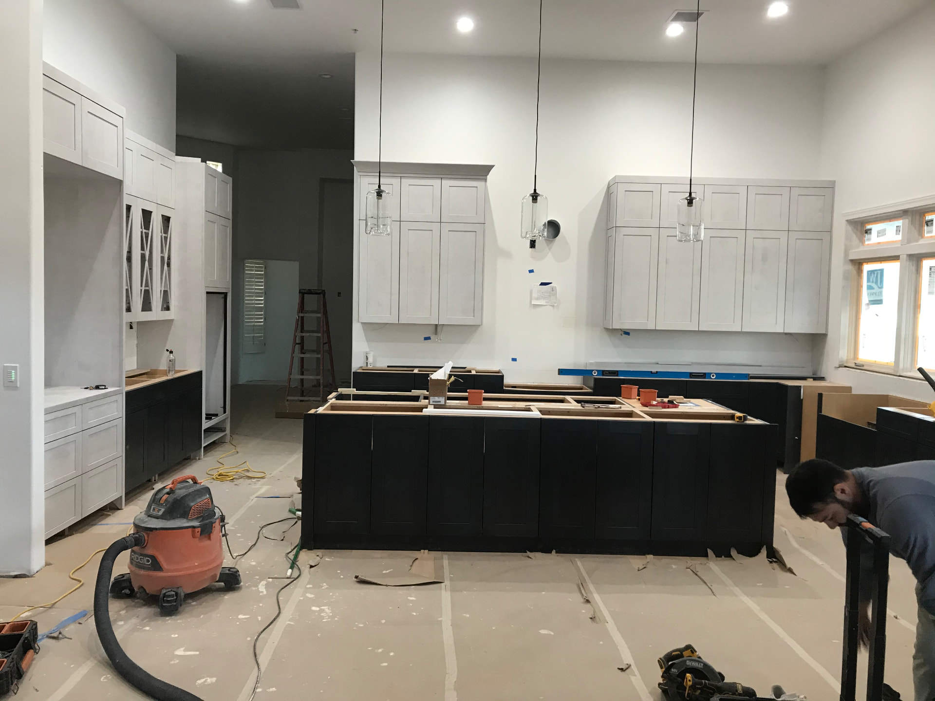 Cabinet island and upper cabinetry set and leveled during installation